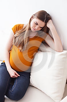 Beautiful expectant mother is expressing her sadness