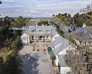 Beautiful, expensive large home on wooded waterfront lot, aerial view photo