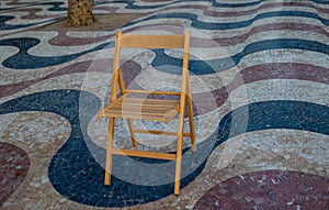 Explanada promenade in Alicante Spain landmark with wooden empty chair on mosaic photo