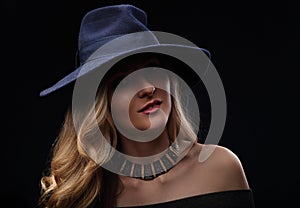 Beautiful expravagant makeup woman posing in fashion blue hat an
