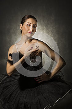 Beautiful expressive ballerina in the role of a black swan