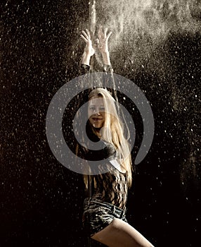 Beautiful expressive dencer dancing at studio with flour