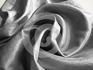 Beautiful fabric - taffeta, gently folded in waves. Crumpled material that looks like silk or brocade. Overflow and color gradient