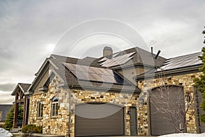 Beautiful facade of a home with stone wall front porch and arched garage doors