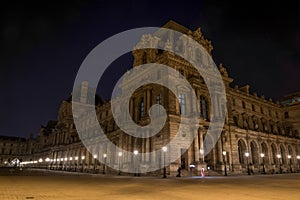 Beautiful facade of the Louvre Palace in Paris at night