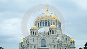 Beautiful facade of the white Cathedral with Golden domes on background cloudy sky. Concept. Popular Russian Cathedral