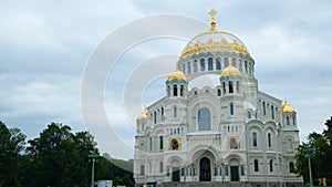 Beautiful facade of the white Cathedral with Golden domes on background cloudy sky. Concept. Popular Russian Cathedral