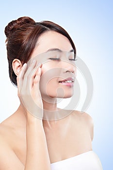 Beautiful face of girl applying moisturize cream