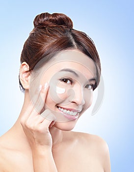 Beautiful face of girl applying moisturize cream