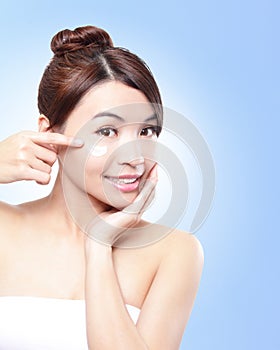 Beautiful face of girl applying moisturize cream photo