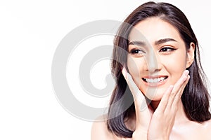Beautiful face skin. Asian woman get beautiful face and nice skin. Attractive beautiful young girl looks at copy space with smiley