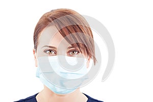 Beautiful face of a woman doctor wearing surgical mask photo