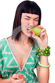 Beautiful face of young woman bitting pear