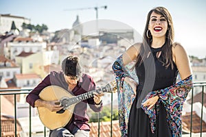 Beautiful fado singer performing with handsome portuguese guitar