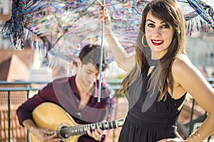 Beautiful fado singer performing with handsome portuguese guitar