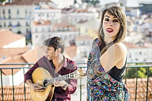 Beautiful fado singer performing with handsome portuguese guitar