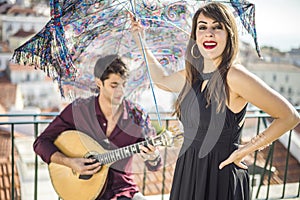 Beautiful fado singer performing with handsome portuguese guitar