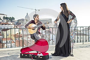 Beautiful fado singer performing with handsome portuguese guitar