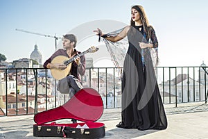 Beautiful fado singer performing with handsome portuguese guitar