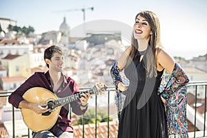 Beautiful fado singer performing with handsome portuguese guitar