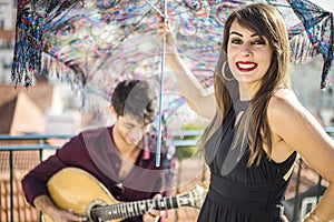 Beautiful fado singer performing with handsome portuguese guitar