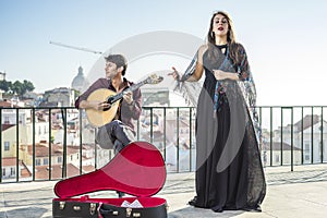 Beautiful fado singer performing with handsome portuguese guitar photo