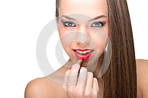 Beautiful fair skinned woman using a red lipstick