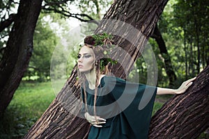 Beautiful fairy woman in forest. Halloween character or Forest soul