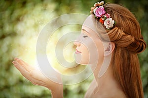 Beautiful fairy woman with glow in hands photo
