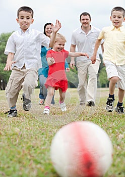 Beautiful family of five on outdoors running