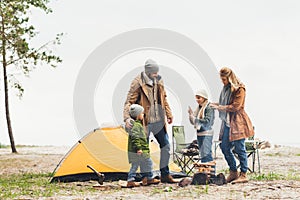 beautiful family having camping trip on cold