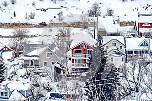 Beautiful family homes at scenic neighborhood in the snowy mountains in winter