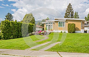 Beautiful family house with parking spot on green lawn of the front yard