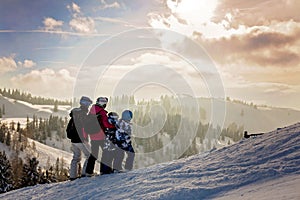 Beautiful family with kids, skiing in a scenery area in Austrian