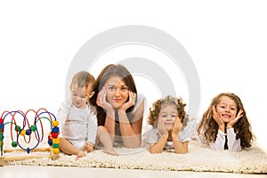 Beautiful family laying in a row on carpet