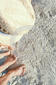 beautiful family legs on the sand by the sea