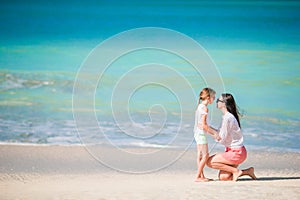 Beautiful family of mom and little girl on beach vacation