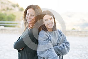 Beautiful family of mother and daugther smiling cheerful, two happy women together as woman power