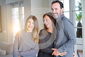 Beautiful family together. Mother, father and daughter smiling and hugging with love at home
