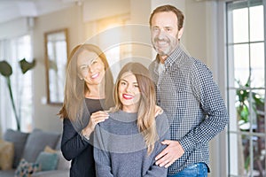 Beautiful family together. Mother, father and daughter smiling and hugging with love at home