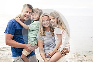 Beautiful family with two children at the beach summer