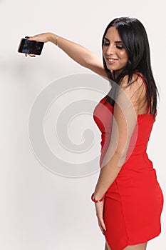 Beautiful, fancy glamourous caucasian girl with black hair posing in studio. Style, trends, lifestyle, glamour. Fashion concept.