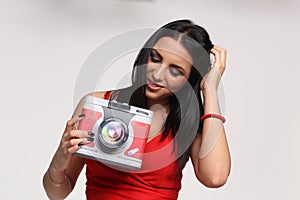 Beautiful, fancy glamourous caucasian girl with black hair posing in studio. Style, trends, lifestyle, glamour. Fashion concept.