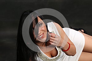 Beautiful, fancy glamourous caucasian girl with black hair posing in studio. Style, trends, lifestyle, glamour. Fashion concept.