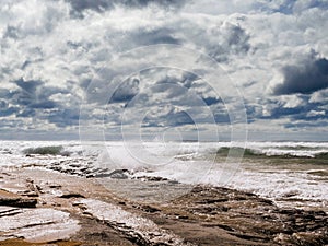 Beautiful Fanore beach, Yellow sand, blue water and cloudy sky, Waves rushing towards the coast, County Clare, Ireland