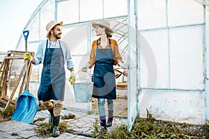 Beautiful farmers near the hothouse outdooors