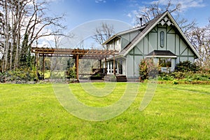 Beautiful farmhouse with attached pergola. Early spring