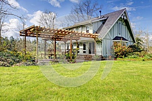 Beautiful farmhouse with attached pergola. Early spring