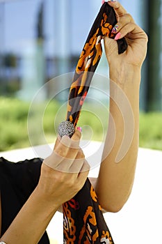 Beautiful fashion east woman portrait.Asian girl in a African violet headscarf praying. Red nail.