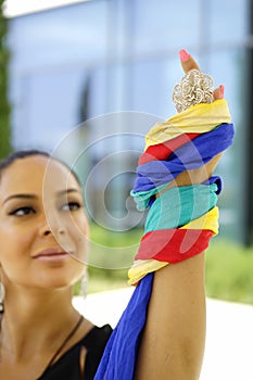 Beautiful fashion east woman portrait.Asian girl in a African violet headscarf praying. Red nail.